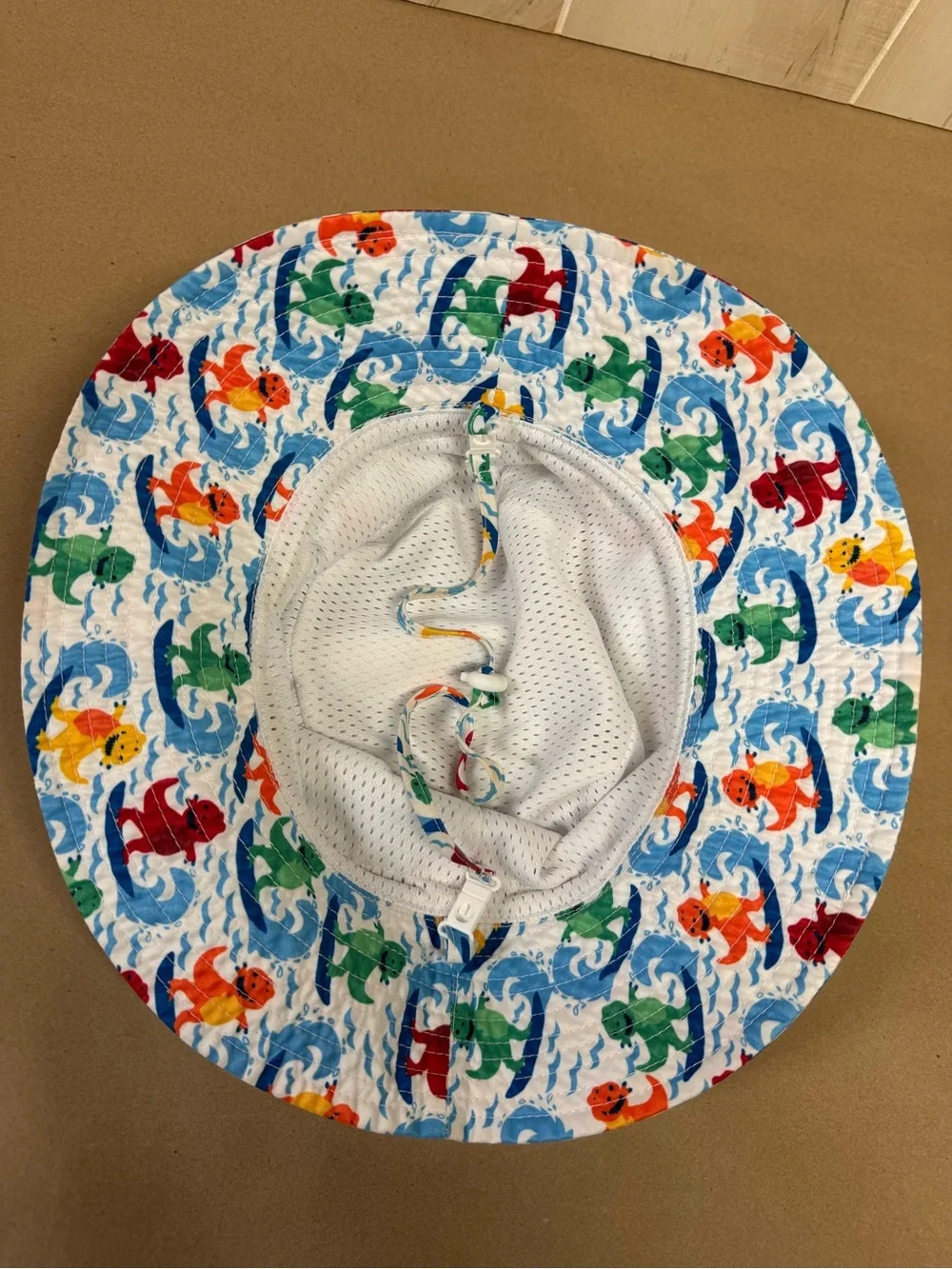 Amazon Kids' White Bucket Hat with Multicolor Surfing Dinosaurs